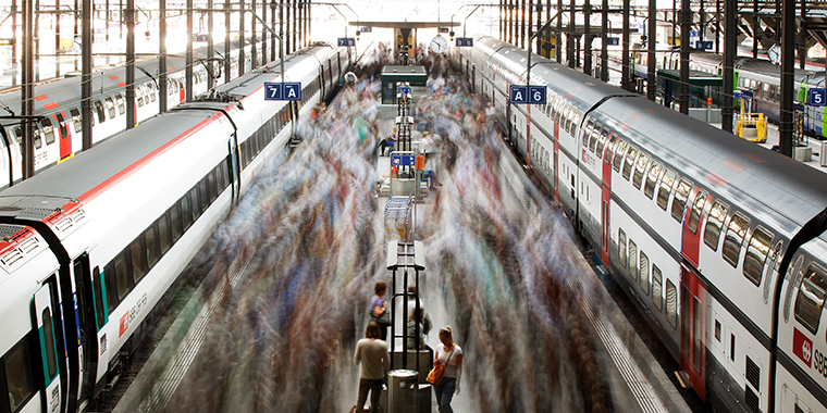 A long exposure picture shows commuters walking on a Swiss Federal Railways platform at the main station in Lucerne on August 7, 2012.