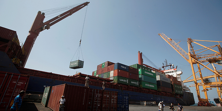 A ship uses its crane to unload containers at a terminal at the Red Sea port of Hodeidah, Yemen on November 16, 2016.