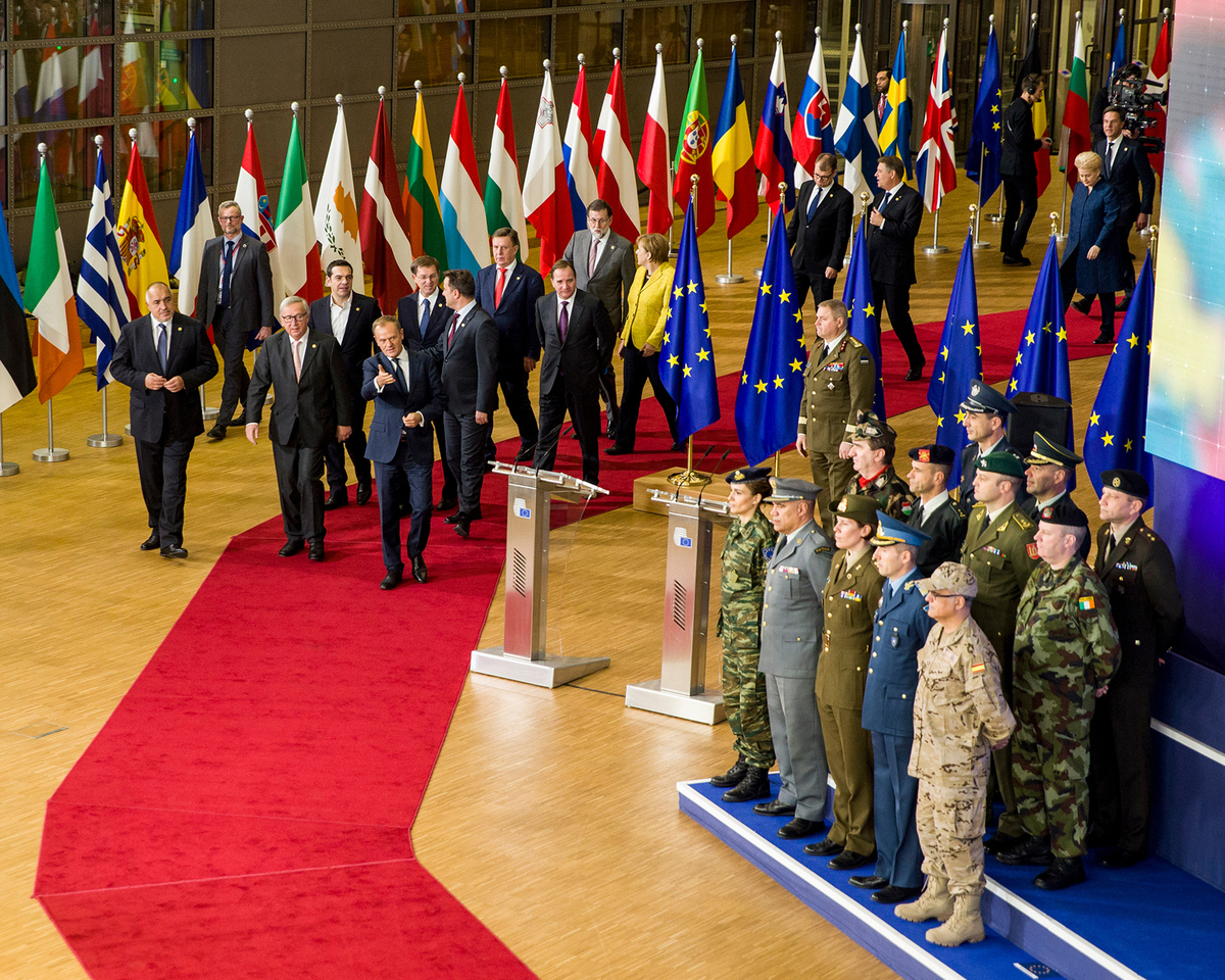 A photo showing European political leaders walking toward the stage with European military leaders at PESCO event in Brussels, Belgium on December 14, 2017.