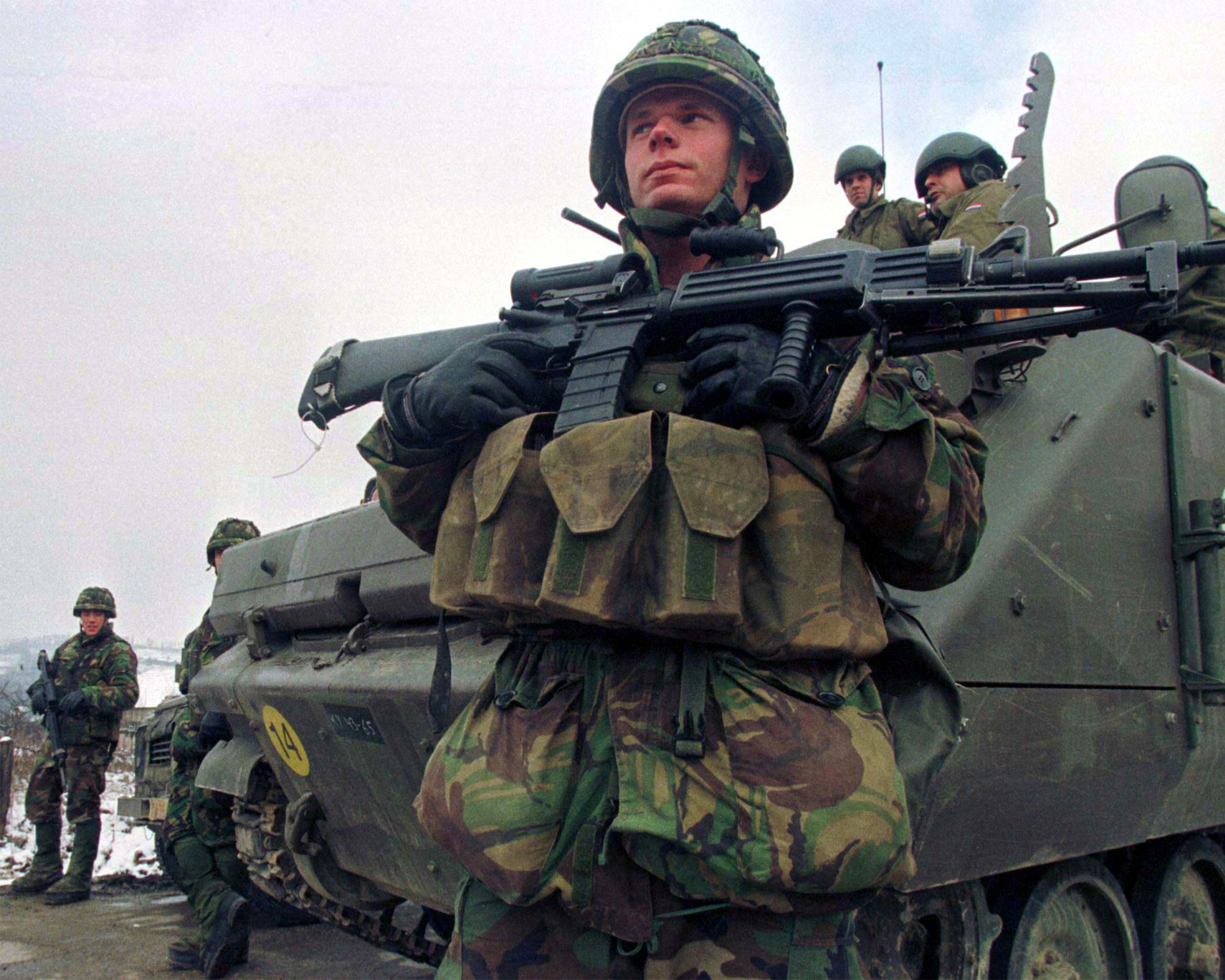 A photo of a Dutch soldier from the NATO-led peacekeeping force in Bosnia standing at a checkpoint in Ahmici, Bosnia on December 18, 1997.