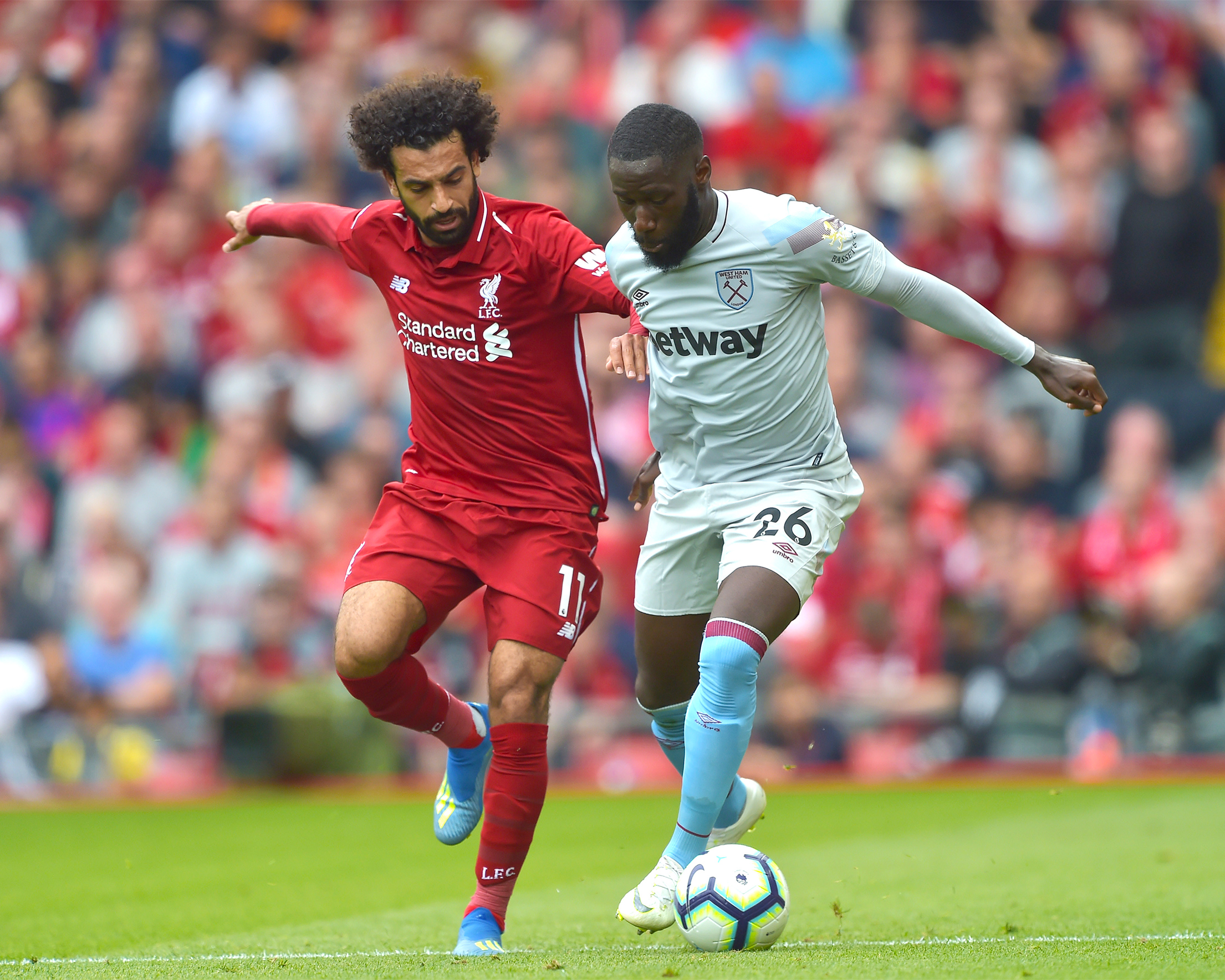 A photo showing Mohamed Salah of Liverpool battling with Arthur Masuaku of West Ham United during the Premier League debut on August 12, 2018 in Liverpool, United Kingdom.
