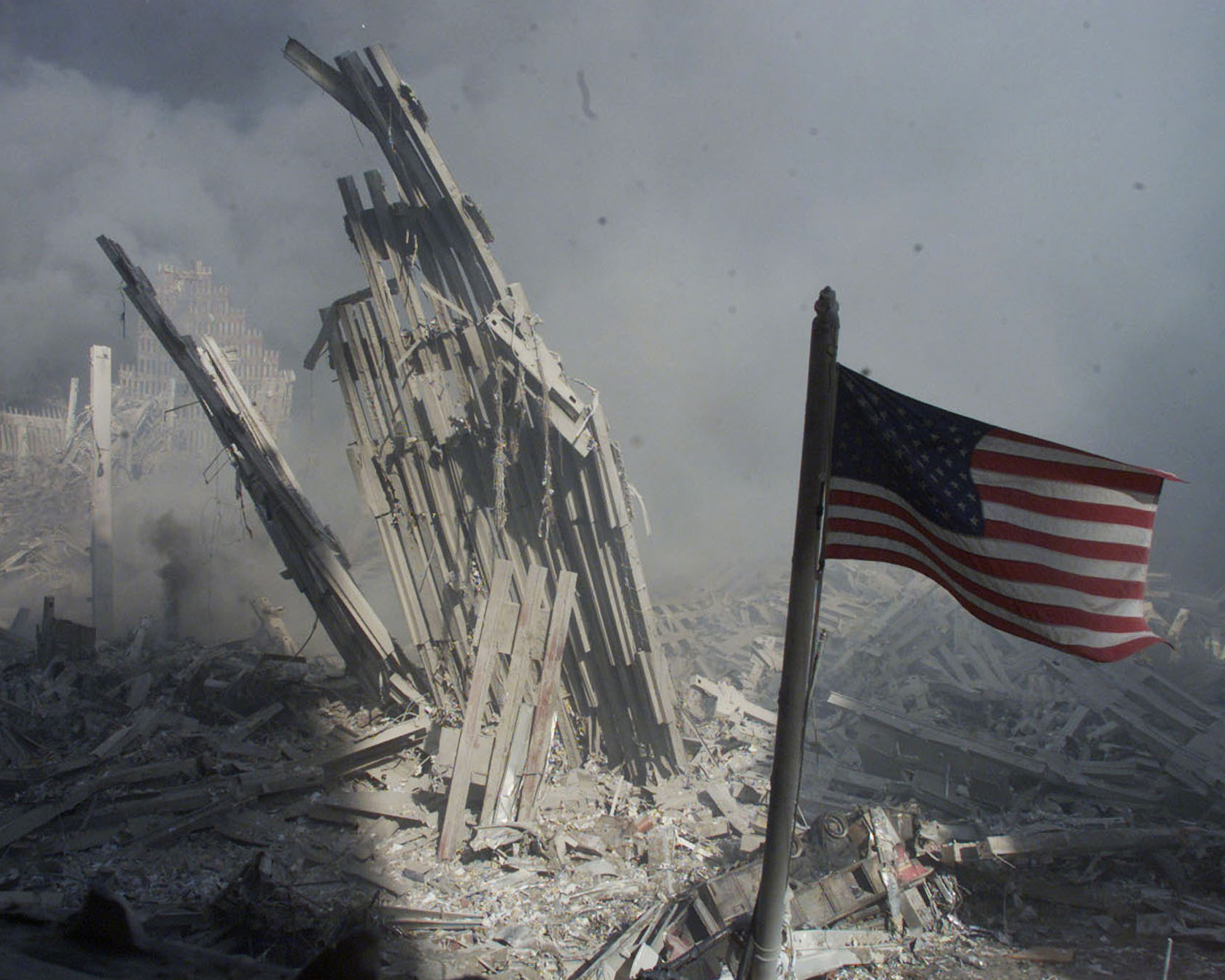 A photo showing an American flag flying near the base of the destroyed World Trade Center in New York on September 11, 2001.
