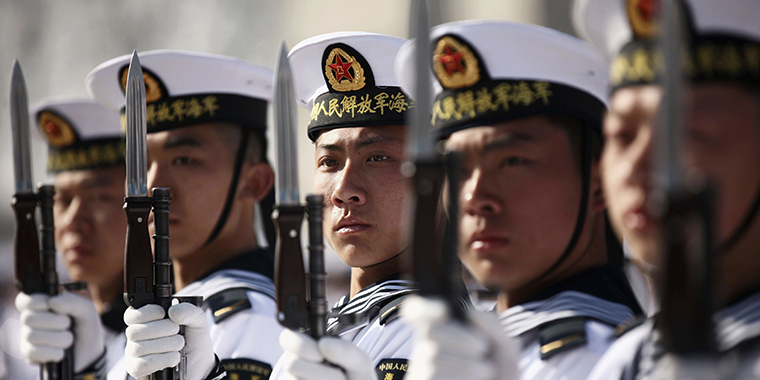 New recruits of the Chinese Navy fleet stand with their guns during the parade marking the end of their first training session in Qingdao on March 4, 2013. 