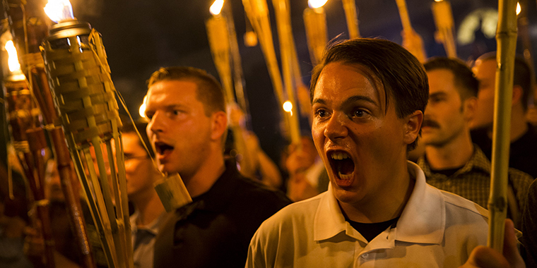 Neo-Nazis, alt-rightists, and white supremacists encircle and chant at counter-protestors with torches at the base of a statue of Thomas Jefferson in Charlottesville, Virginia, on August 11, 2017.