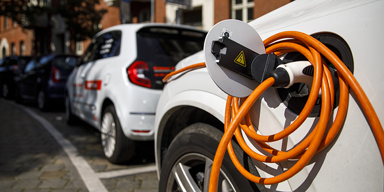 Electric cars stand in front of a charging station in a residential area in the Prenzlauer Berg district of Berlin on September 2, 2021.