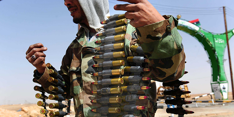 Defected Libyan soldiers attempt to load an ammunitions magazine into an anti-aircraft gun on the border of the eastern town of Ajdabiya on January 3, 2011.