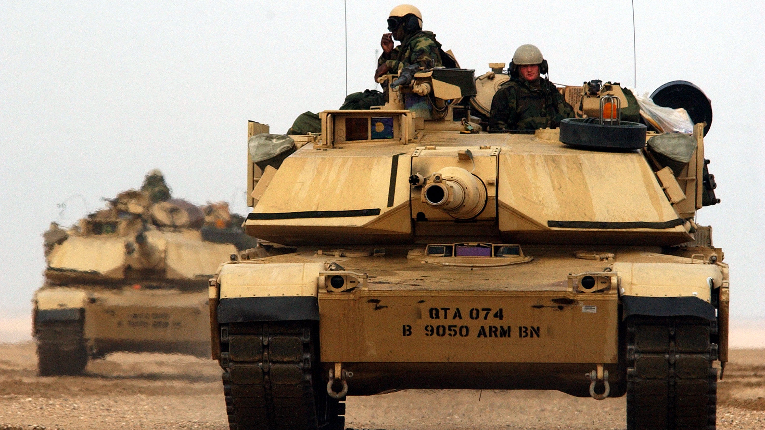  M1/A1 Abrams tanks from the Charlie company 464 Armored Battalion depart for task force manuevers December 17, 2002 near the Iraqi border in the Kuwaiti desert.