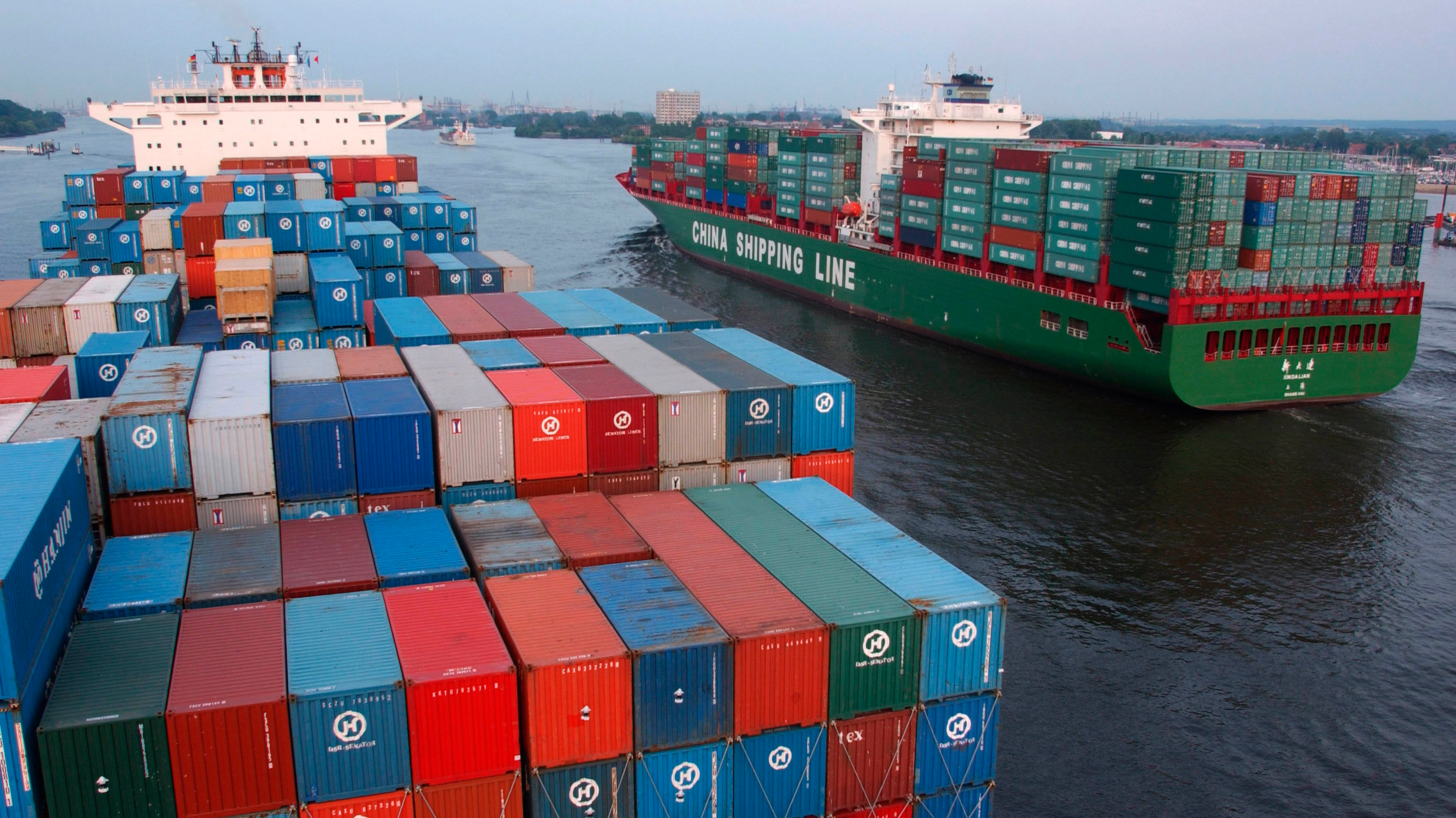 Container ships from China passing at Blankenese on the Elbe, Germany.