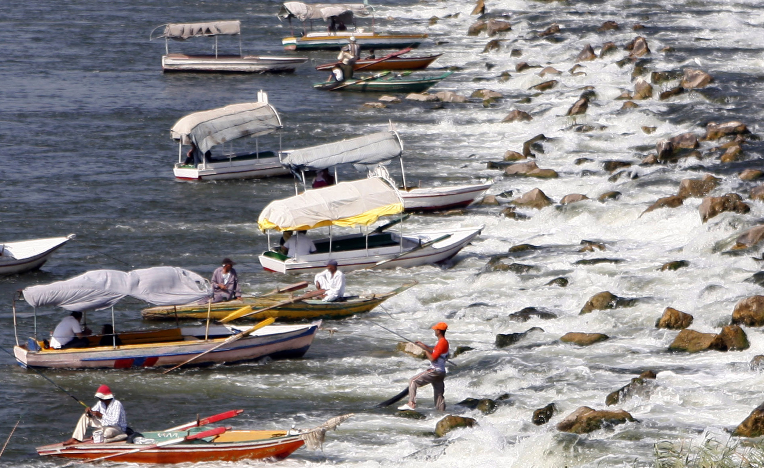 Egyptians fishing on small boats.