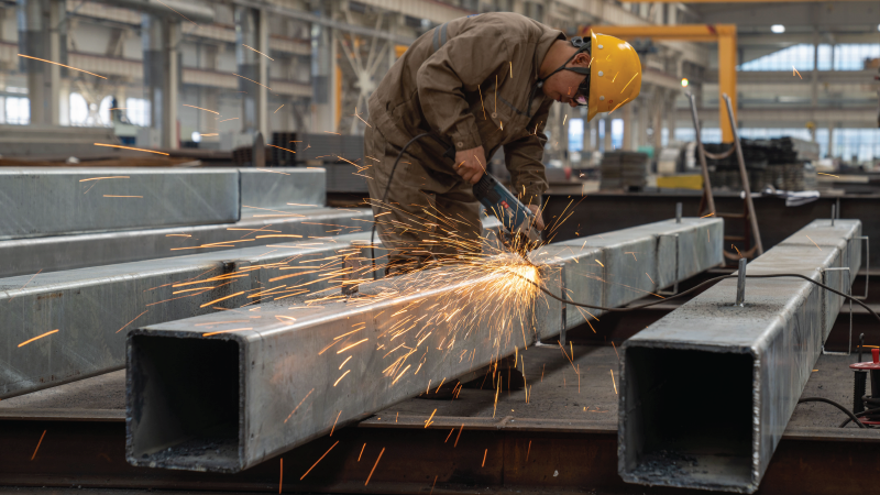 In this photo a steel-worker takes a welding device to a large steel structure at a Chinese manufacturing plant. 