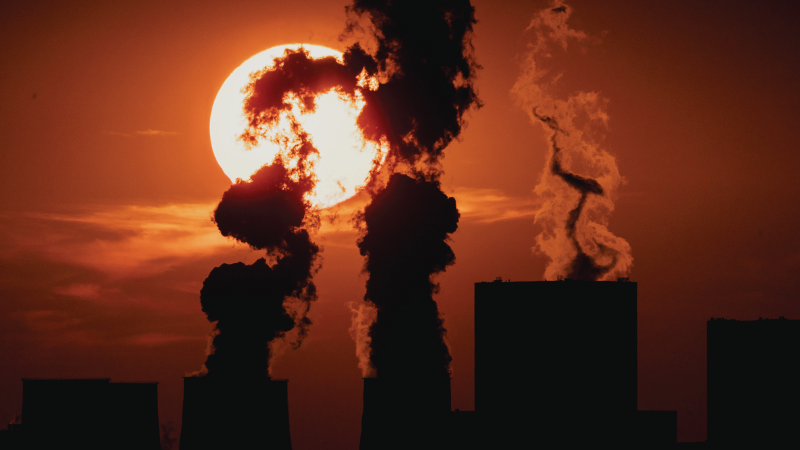 Sun sets behind a coal-fired power plant in Neulibel, Germany