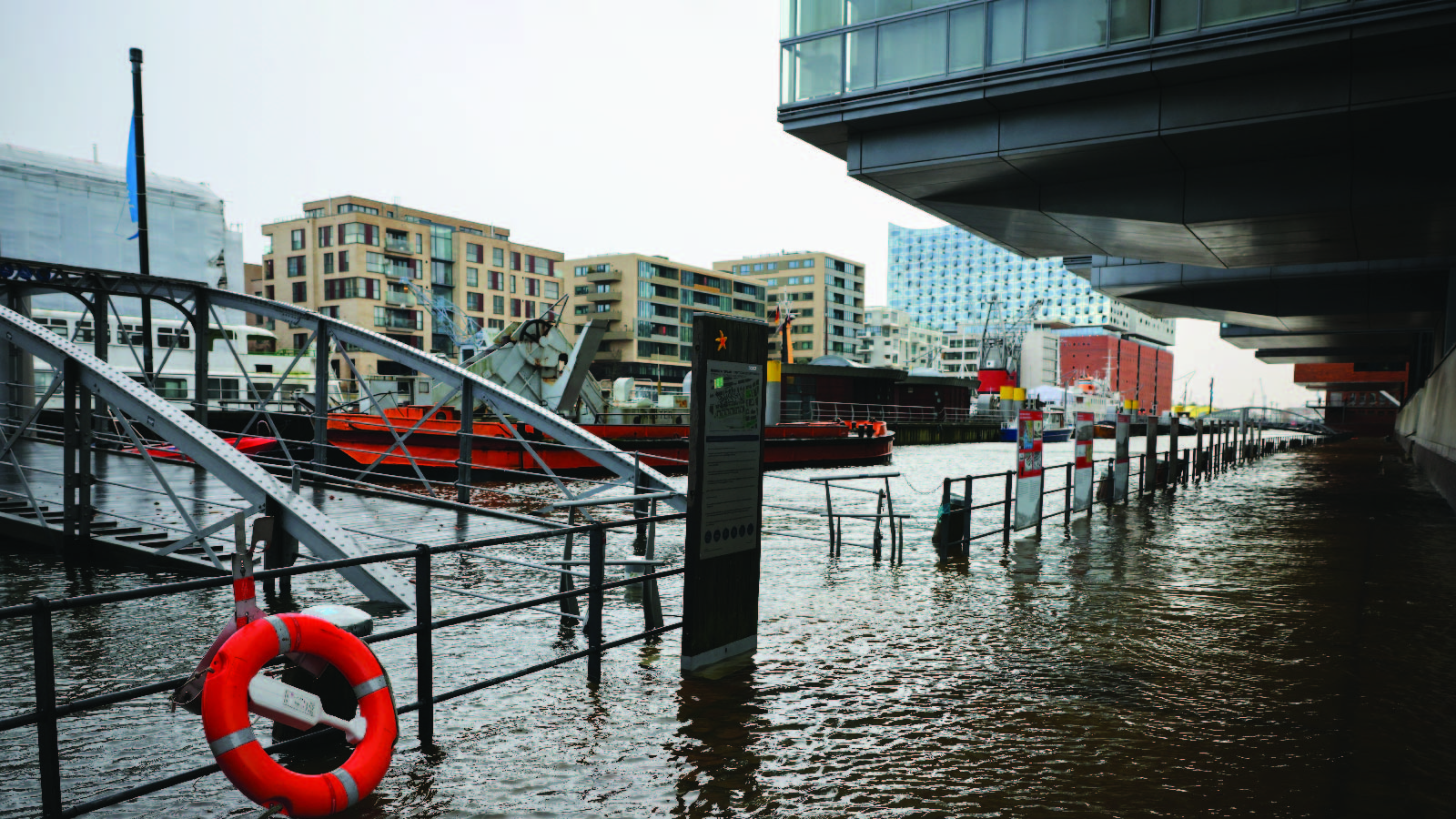 Water floods the promenade at a ship harbor in Hamburg, Germany