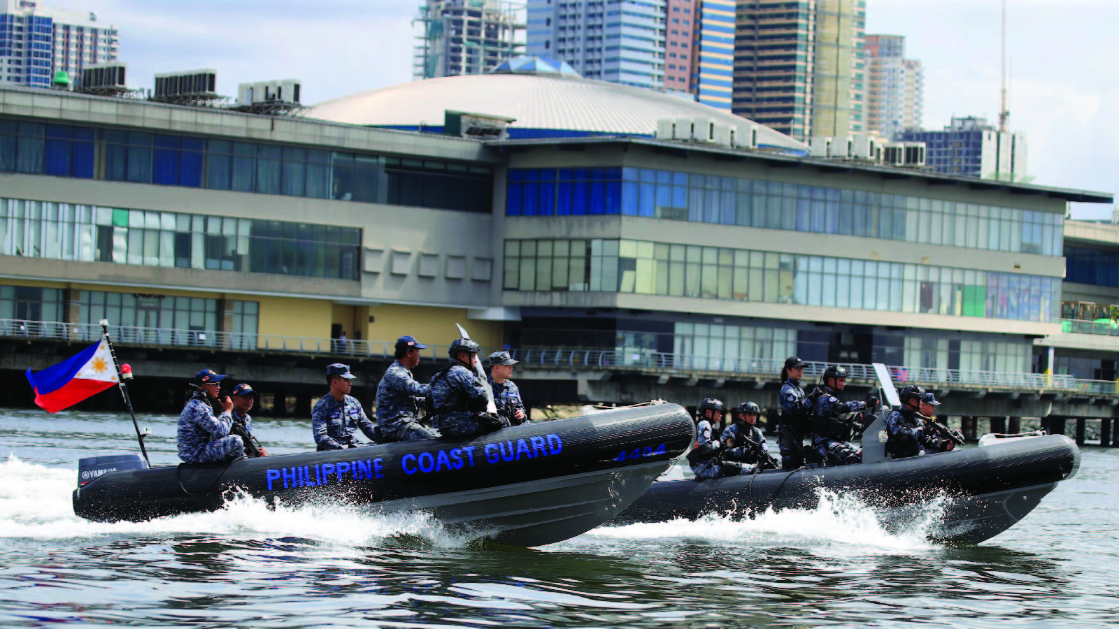 Members of the Philippine Coast Guard (PCG) Special Operations Group patrol the coast in Manila, Philippines