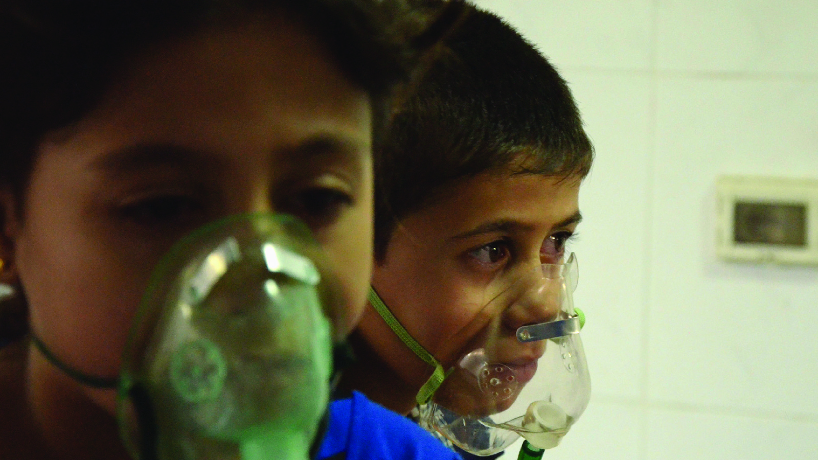 Children, affected by an apparent gas attack, breathe through oxygen masks in Damascus, Syria, on August 21, 2013.