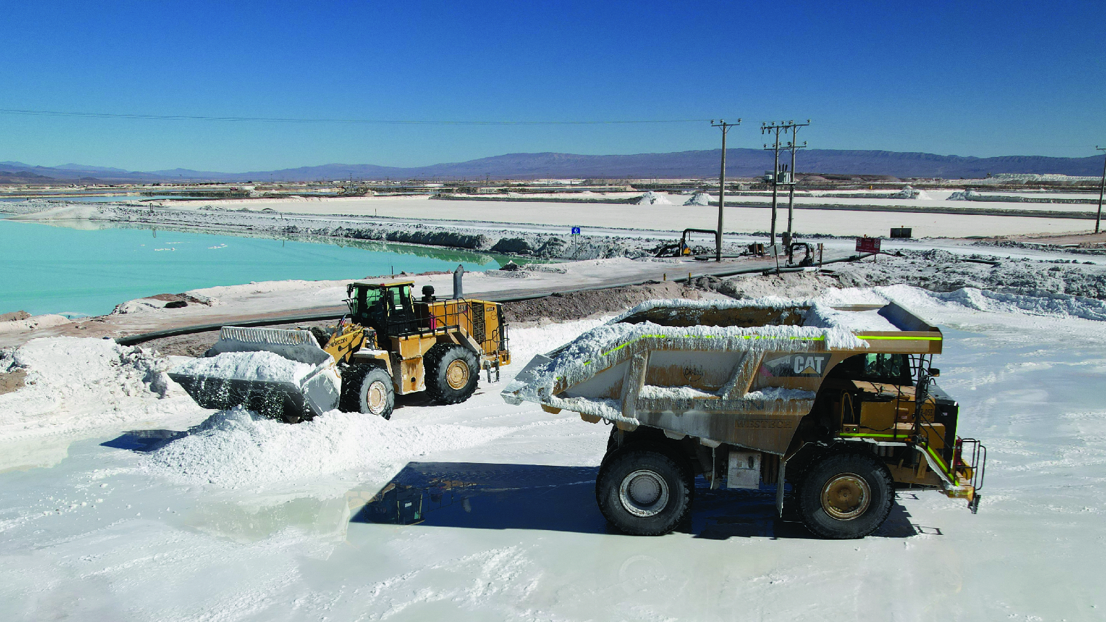 Mining trucks load lithium sulfate in the Atacama Desert, Chile, on July 29, 2024.