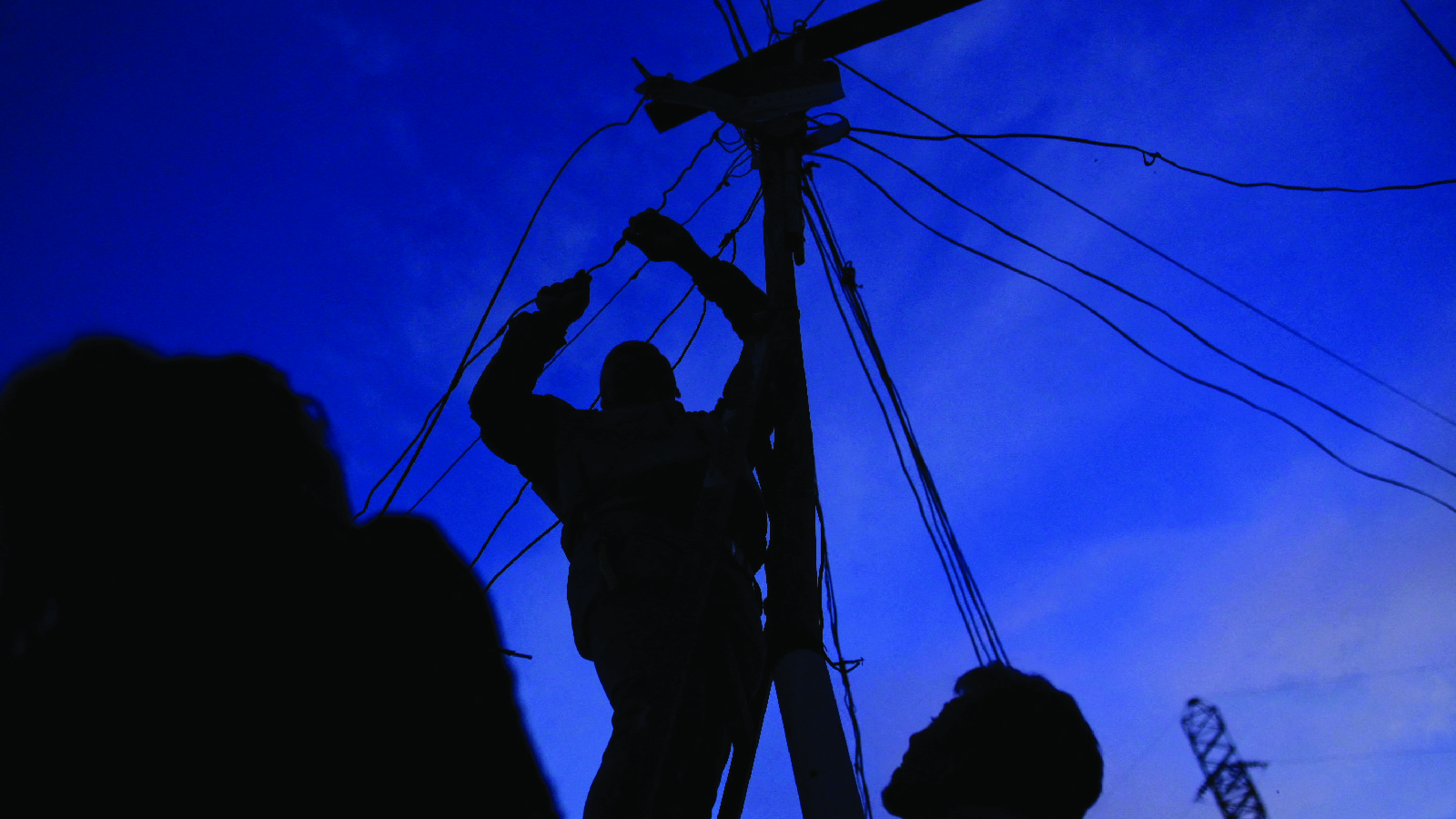 A man connects power cables during a power outage in Caracas, Venezuela on August 30, 2024.