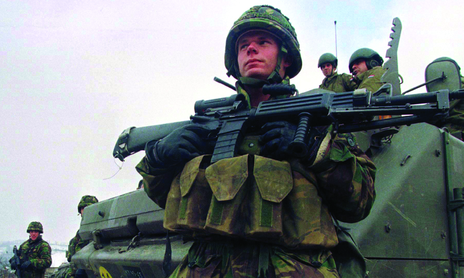 A Dutch soldier from the NATO-led peacekeeping force in Bosnia stands at a checkpoint in Ahmici, Bosnia on December 18, 1997.