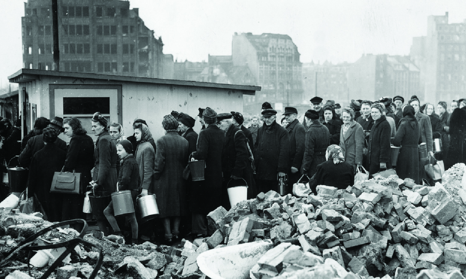 Citizens of Hamburg, Germany line up among the city's ruins for soup rations on March 26, 1946.