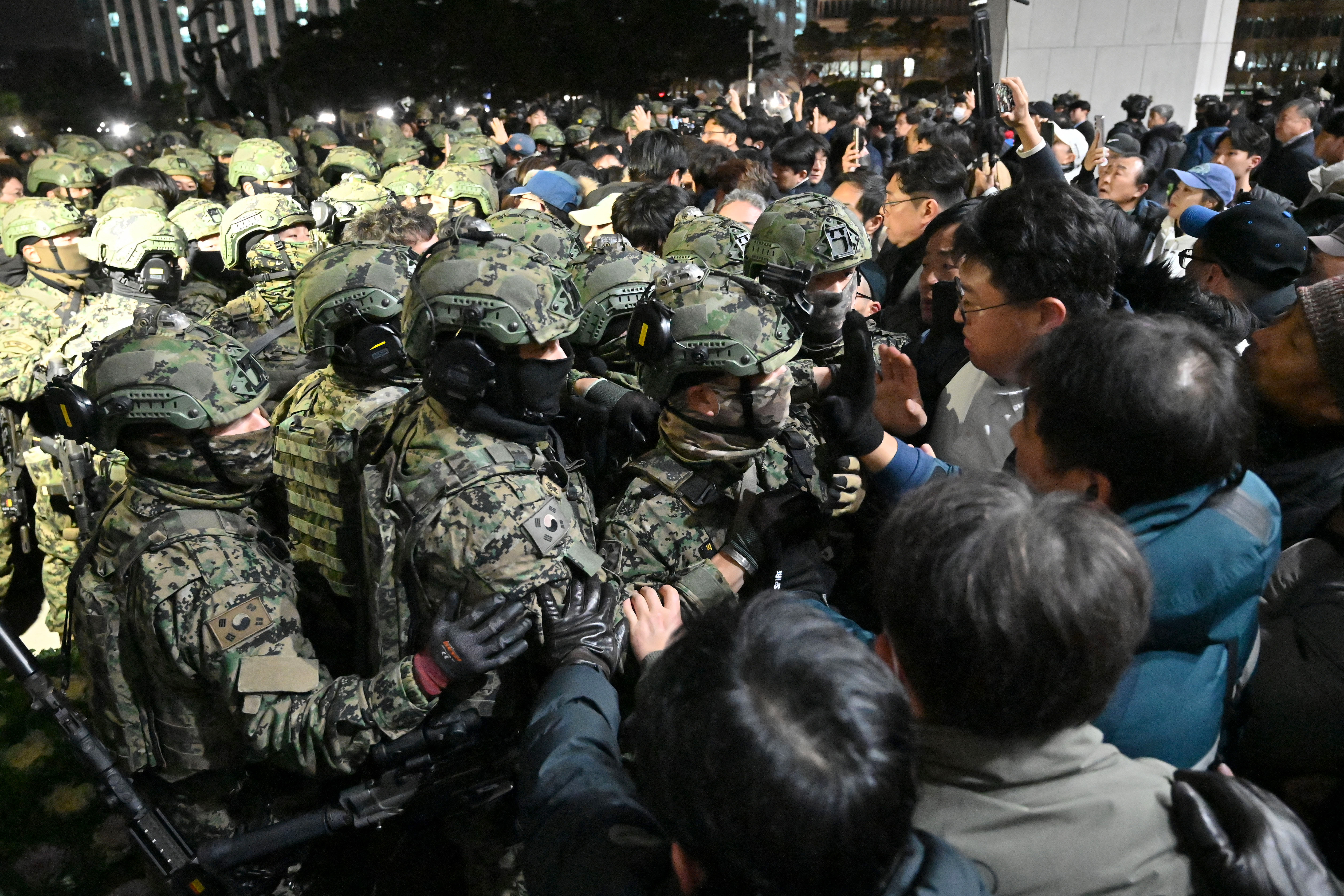 A photo of soldiers being blocked by protesters from entering the National Assembly building after South Korean President Yoon Suk Yeol declared martial law in Seoul, South Korea.