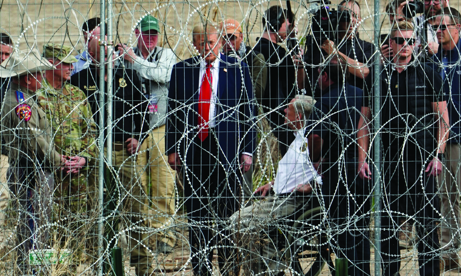 U.S. President Donald Trump speaks with Texas Governor Greg Abbott during a visit at the U.S.-Mexico border at Eagle Pass, Texas, as seen from Piedras Negras, Mexico, February 29, 2024. 