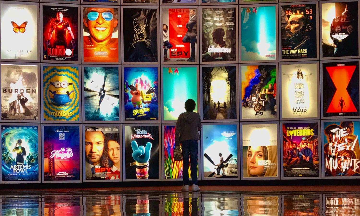  A child looks at movie posters inside the lobby of the Arclight movie theater.