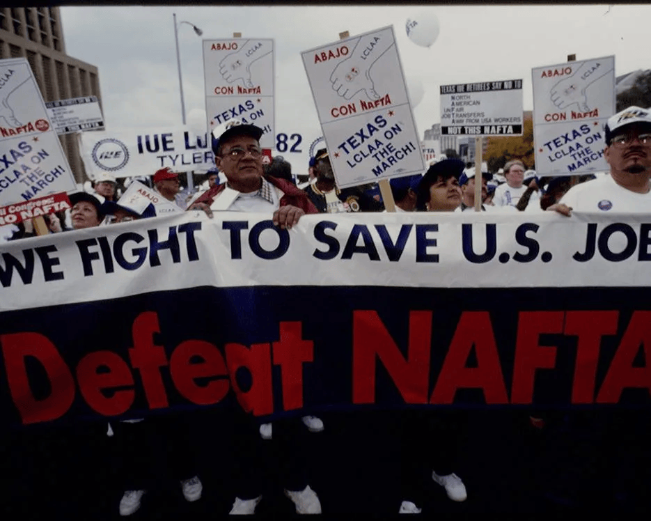 Demonstrators hold a banner reading "We fight to save U.S. jobs" at a demonstration against NAFTA.