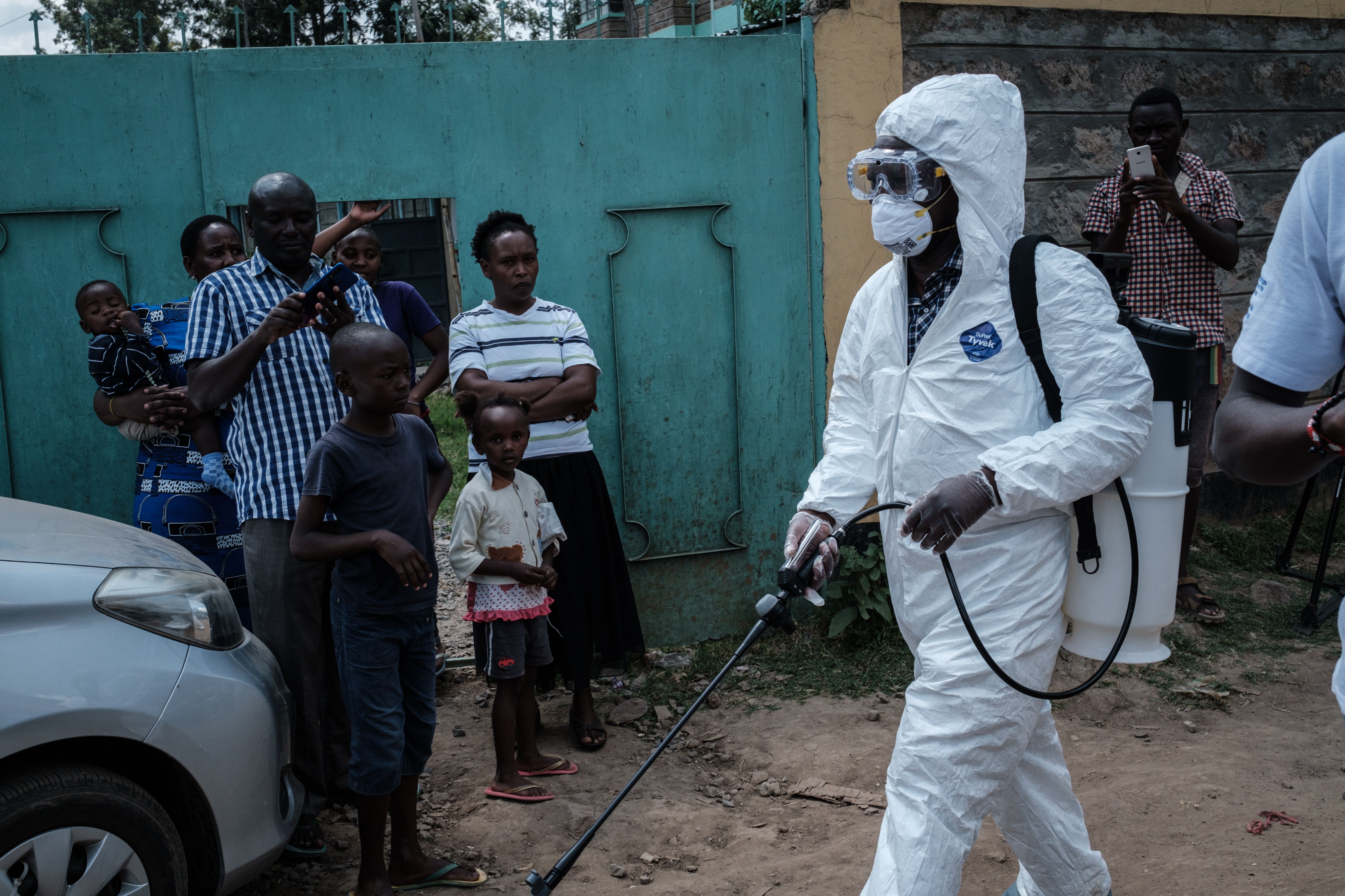 : A health worker wearing protective gear prepares to disinfect the minibus in which the first Kenyan patient of the COVID-19 travelled, in Ongata Rongai, neighboring town of Nairobi in Kenya, on March 14, 2020.