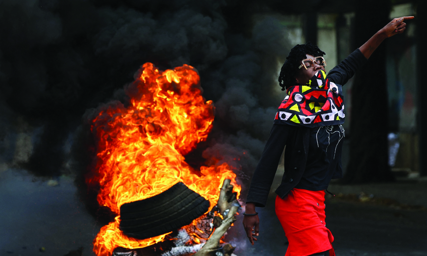A protester reacts near a burning barricade during a "national shutdown" against the recent election outcome, at Luis Cabral township in Maputo, Mozambique, on November 7, 2024.
