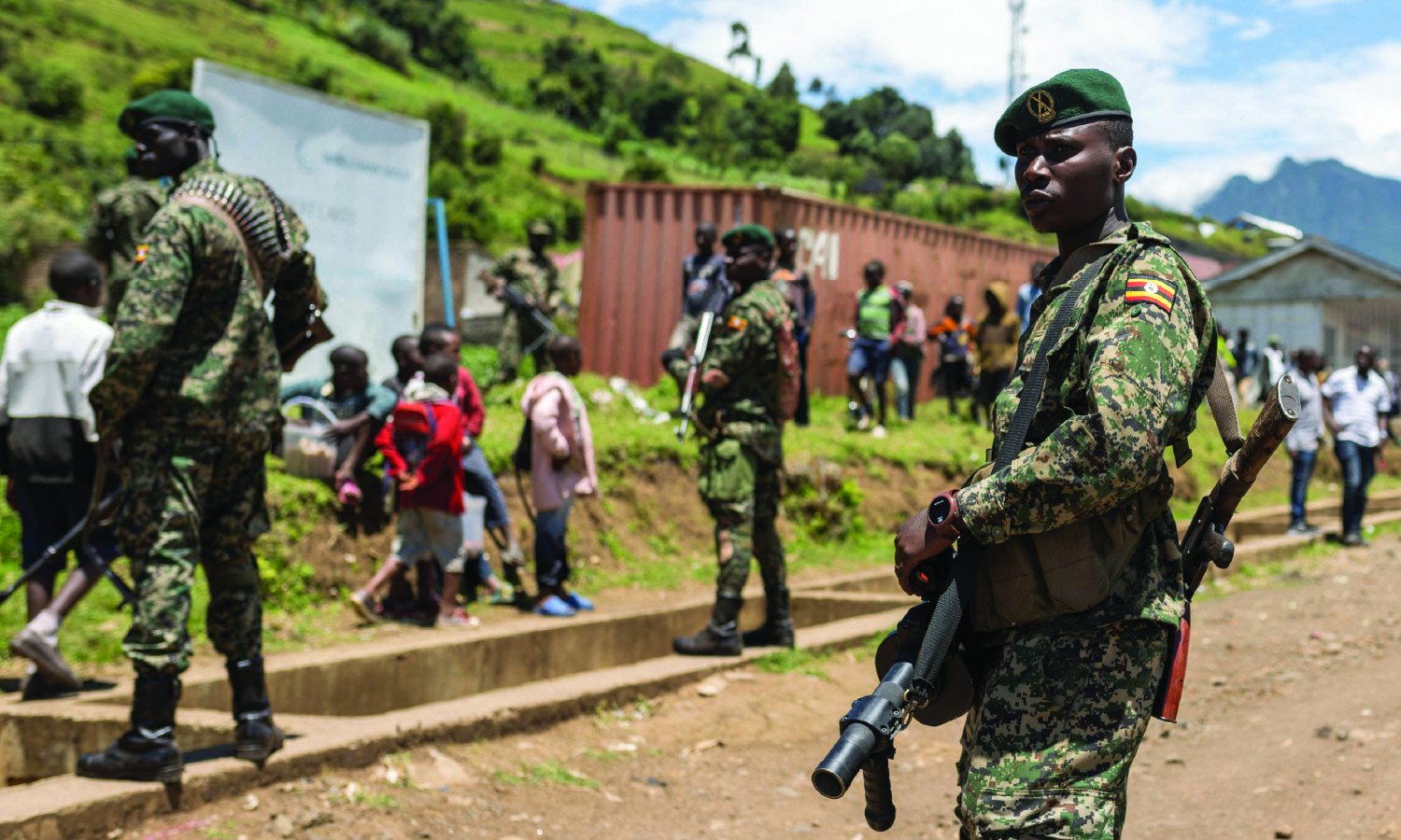 Members of the Ugandan army stand in a formation as they patrol a settlement ceded by M23 rebels fighters to EACRF soldiers in the North Kivu province of the Democratic Republic of Congo.