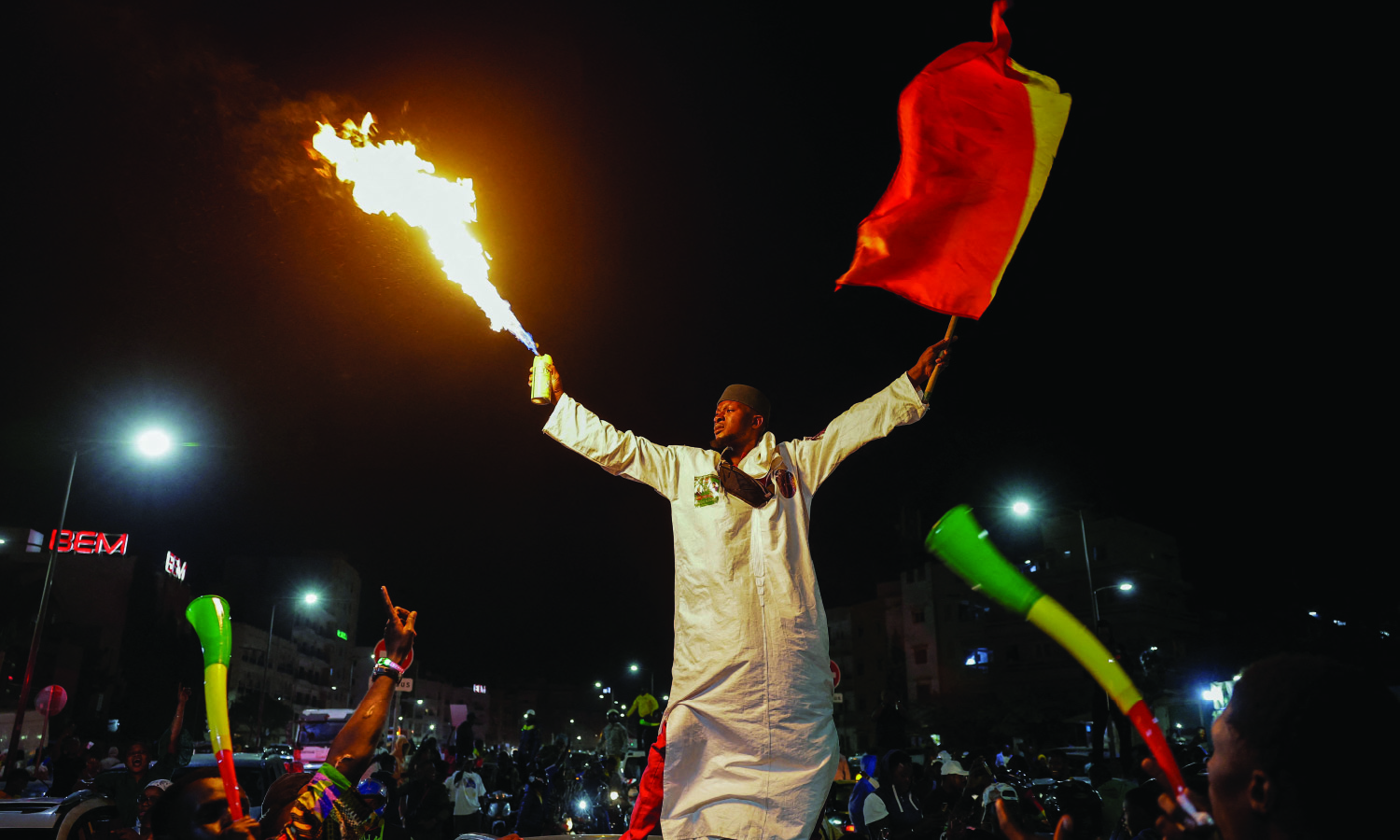 A supporter celebrates after Senegalese opposition leader Ousmane Sonko and the presidential candidate he is backing in the March 24 election, Bassirou Diomaye Faye, were released from prison, in Dakar, Senegal on March 14, 2024. 