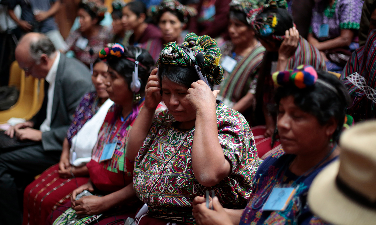 An indigenous woman of the Ixchil region listens with headphones during testimony against former Guatemalan dictator Efrain Rios Montt at the Supreme Court of Justice in Guatemala City.
