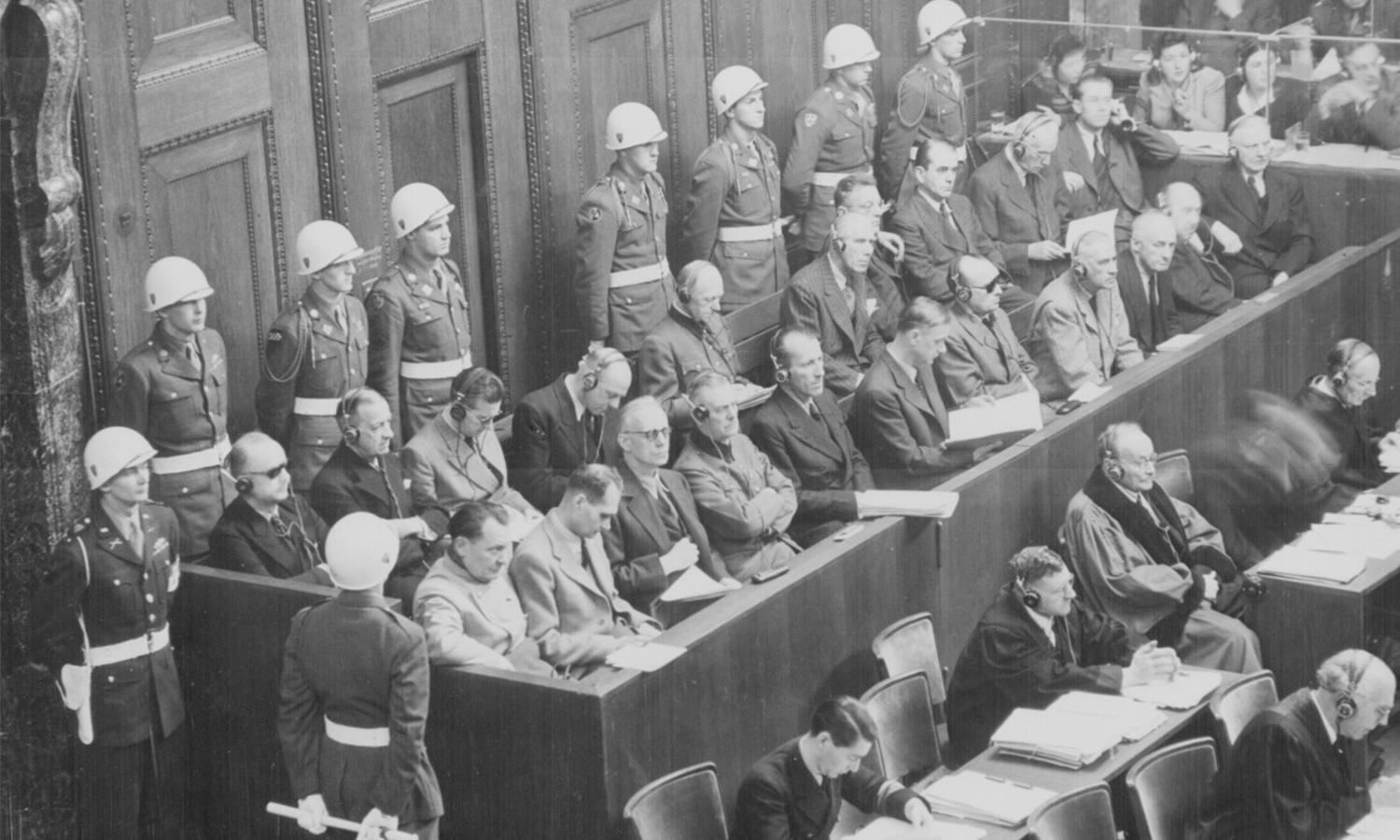 A black and white photo of the view of the defendants' dock during the Nuremberg Trials in Nuremberg, Germany.