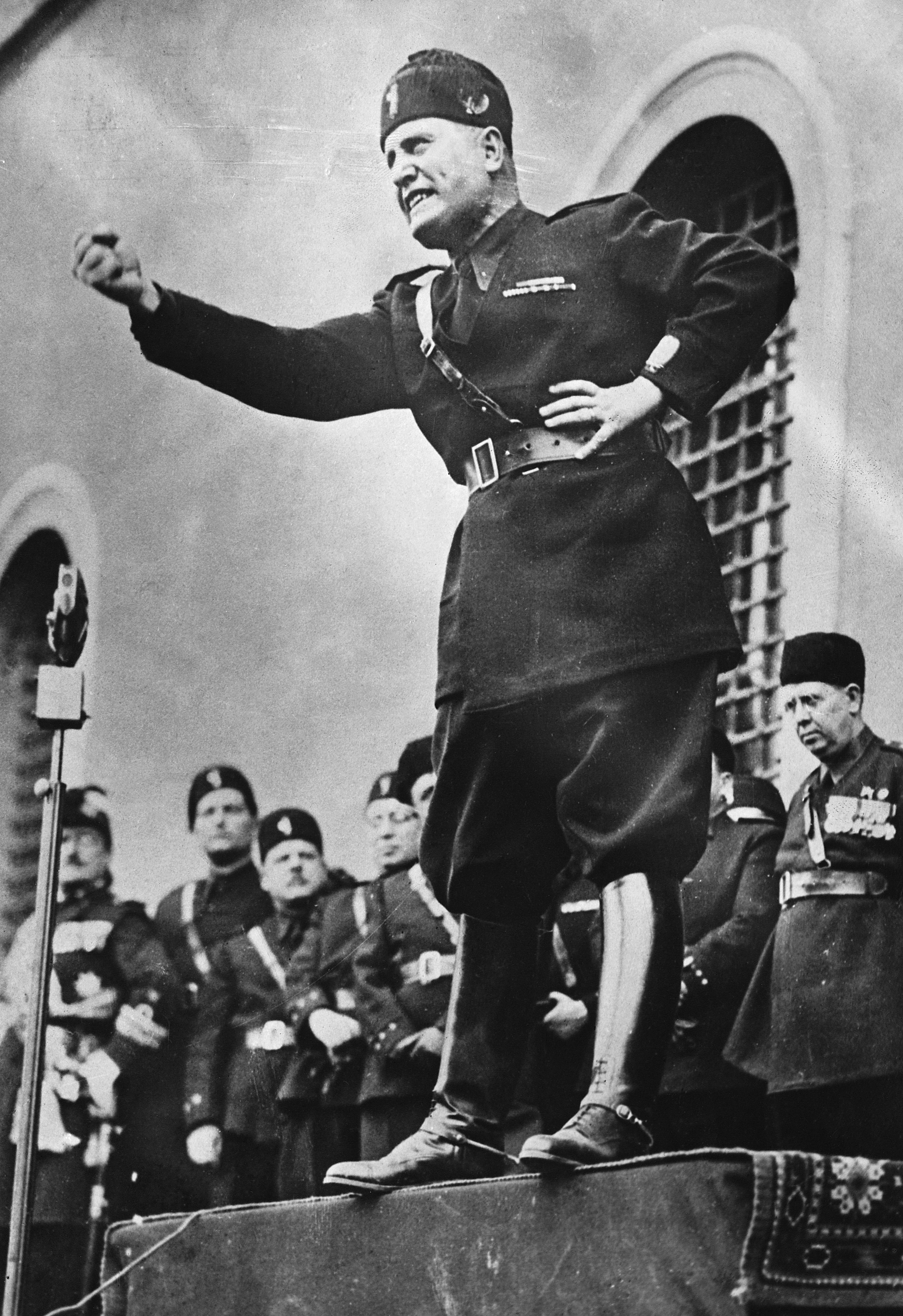 Benito Mussolini assumes a characteristic pose as he speaks to an audience in Italy in 1934. Source: Corbis via Getty Images.