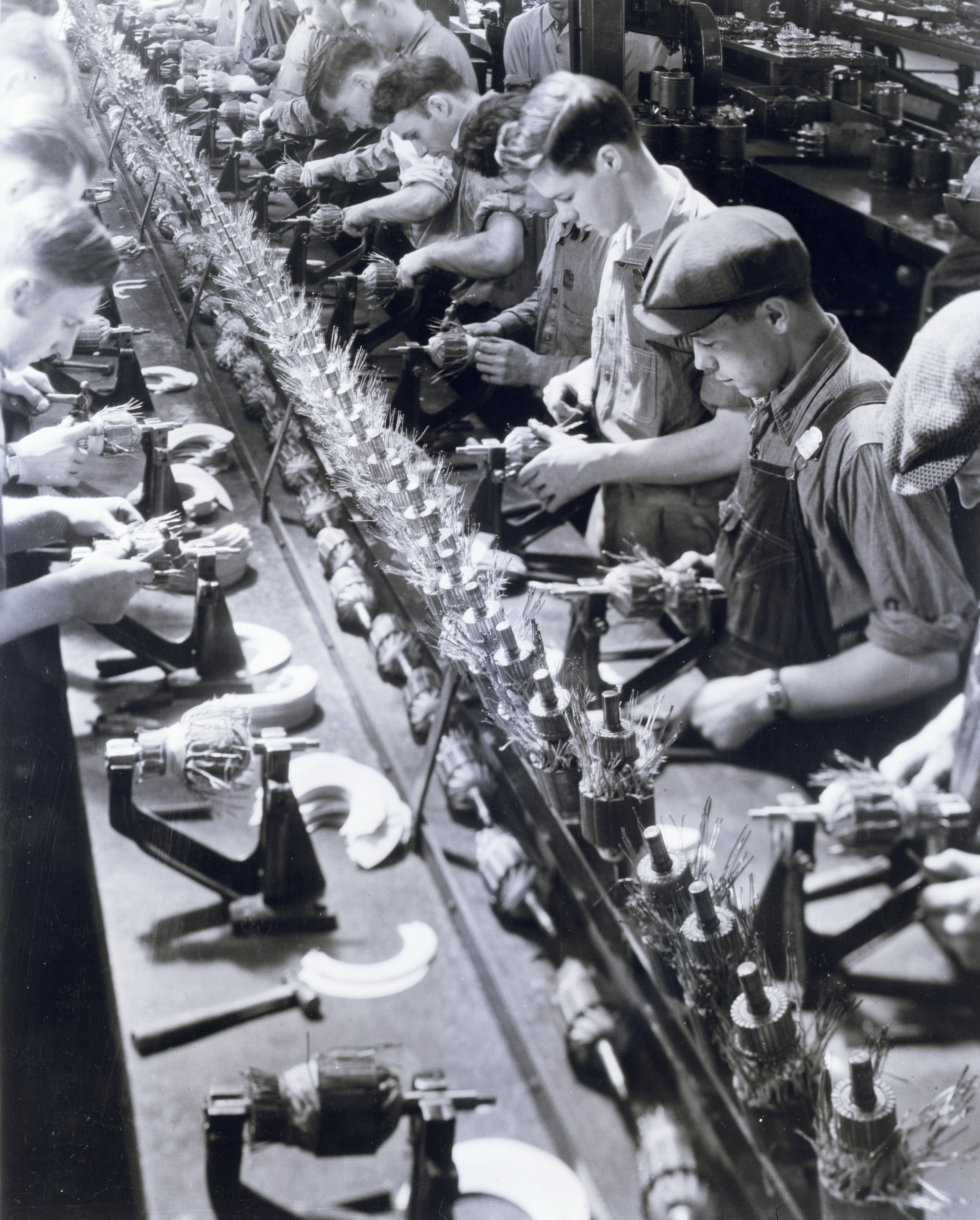 Men on an assembly line work on Ford generators in a small plant at Ypsilanti, Michigan, about 2.5 miles from Dearborn. Source: Bettmann Archive via Getty Images.