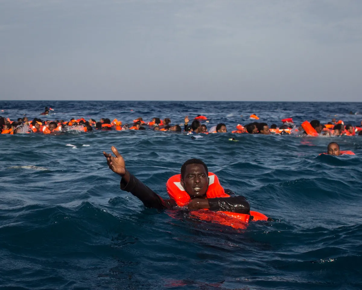 A photo showing refugees and migrants requesting help from a Migrant Offshore Aid Station vessel after their Italy-bound wooden boat capsized off the coast of Lampedusa on May 24, 2017.