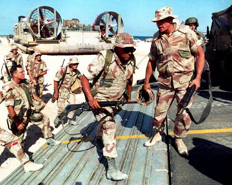 A photo showing U.S. Marines boarding hovercraft on March 23, 1994 as part of the final contingent of US troops to evacuate Somalia.