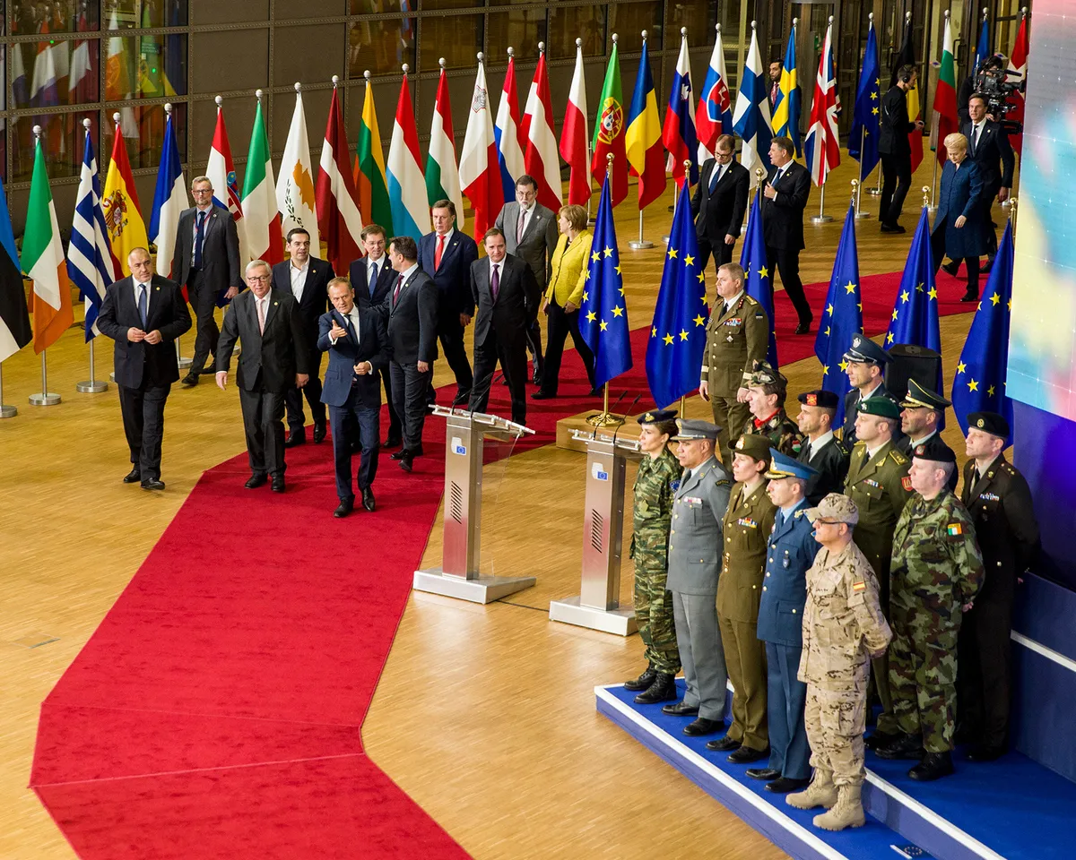 A photo showing European political leaders walking toward the stage with European military leaders at PESCO event in Brussels, Belgium on December 14, 2017.