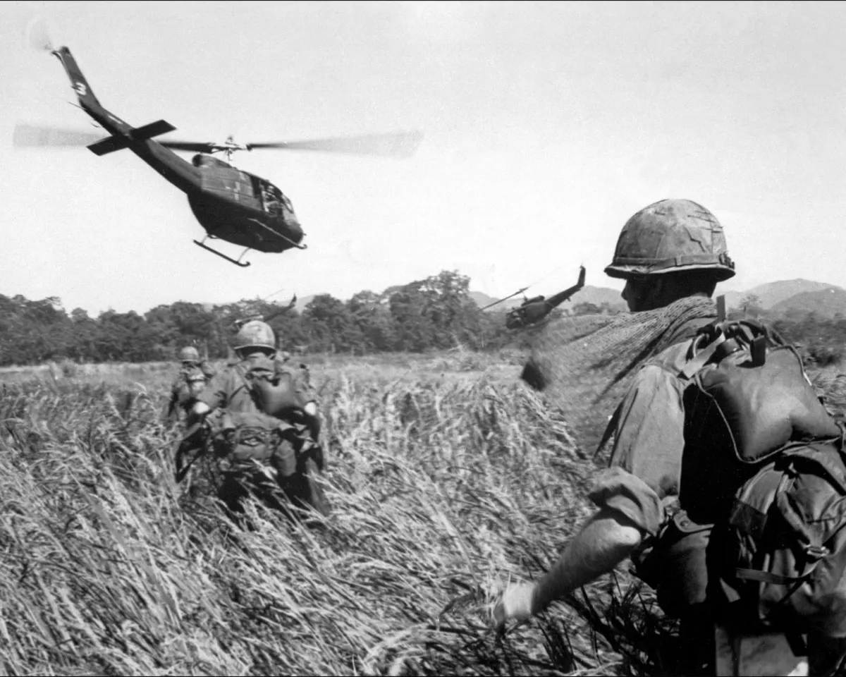 A photo showing U.S. soldiers being evacuated by helicopter from a Vietcong position on December 11, 1965 in Vietnam.