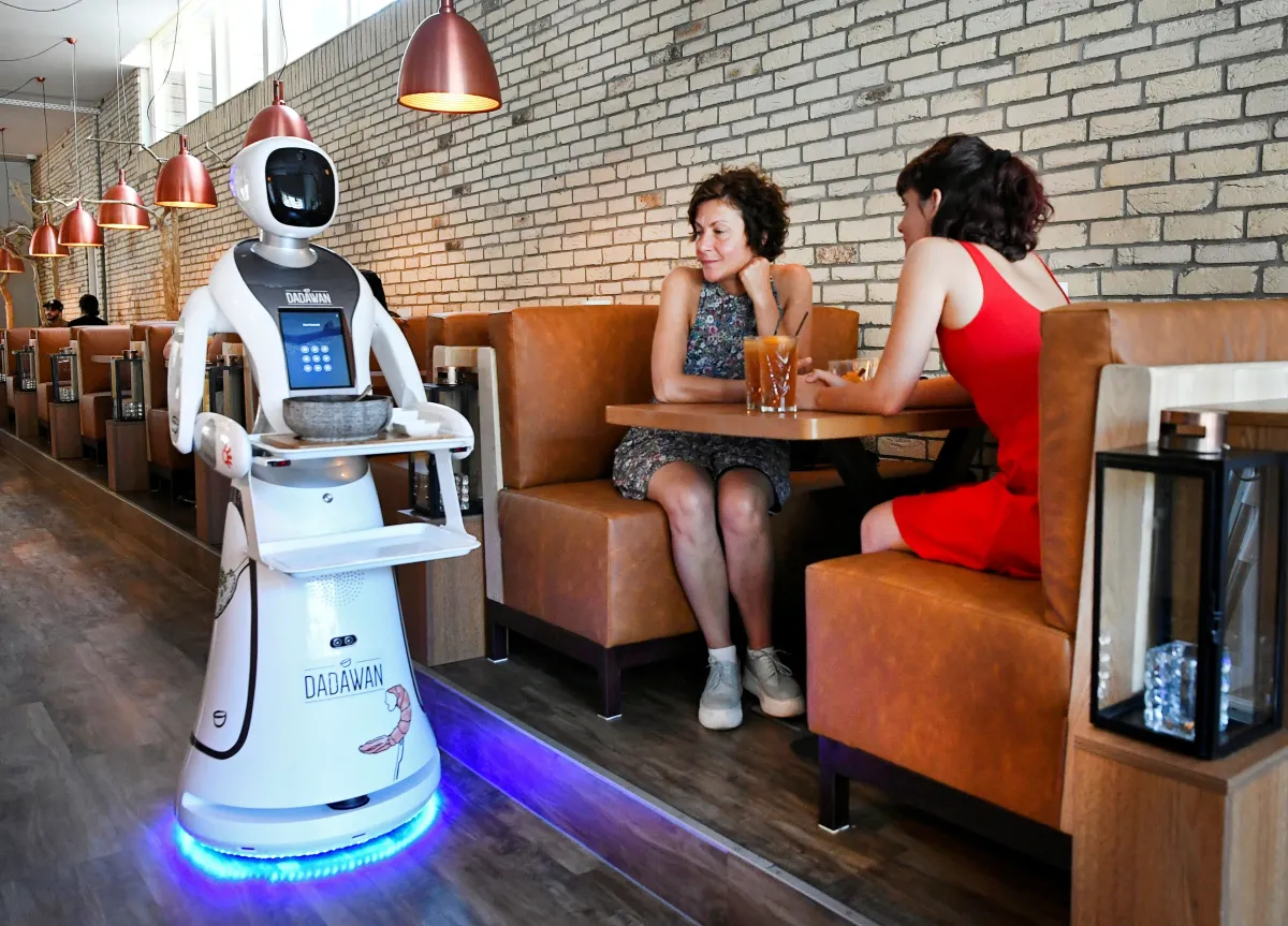 Robotic server takes diners' orders.