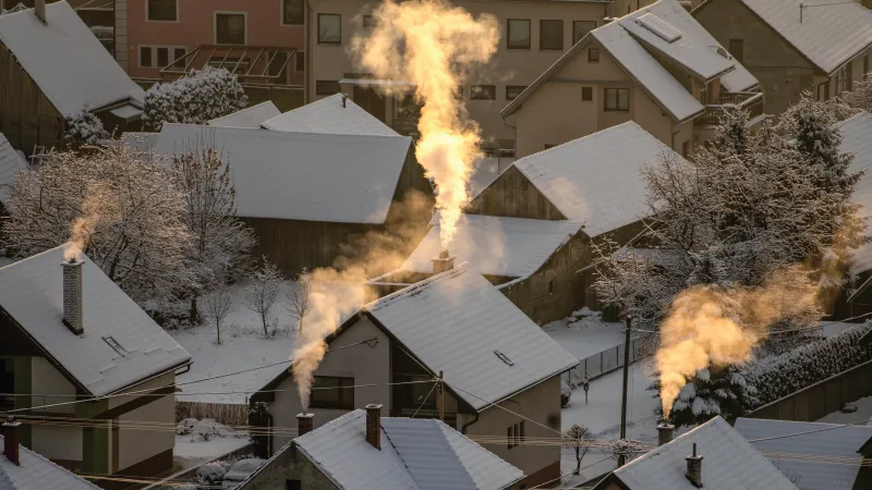 Houses with smoke coming out of the chimney in Winter