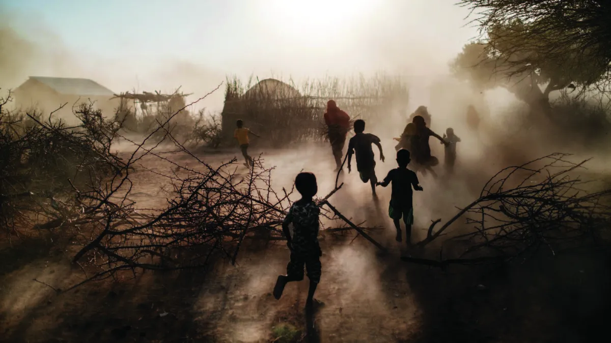 Children and women run through the village of El Gel, Ethiopia on January 12, 2023. The Horn of Africa region is experiencing extreme drought, conflict, and food insecurity. 