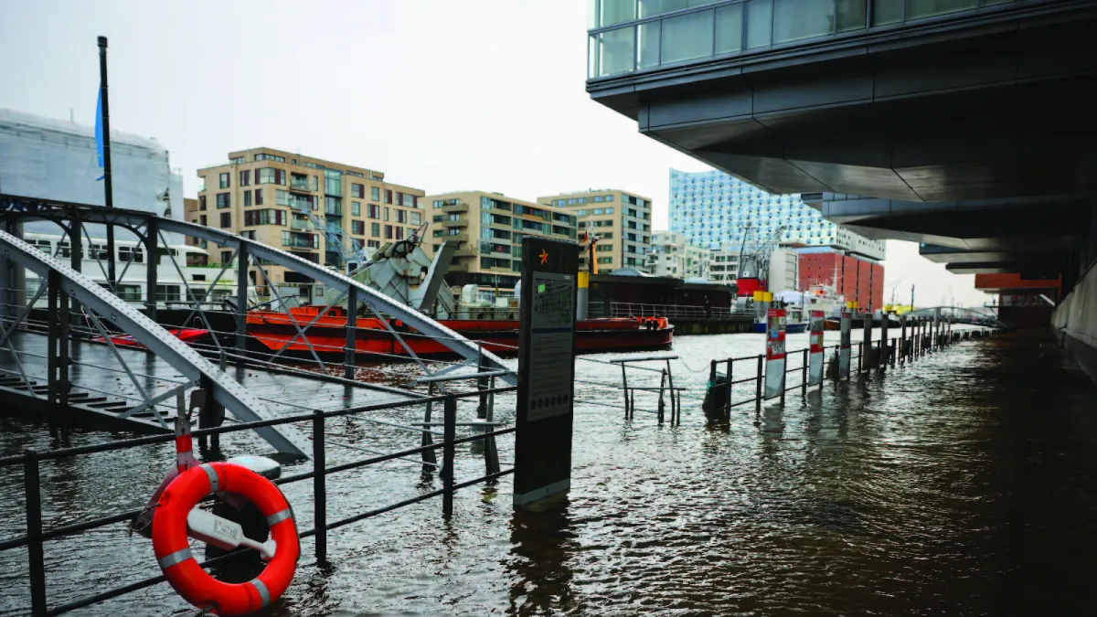 Water floods the promenade at a ship harbor in Hamburg, Germany