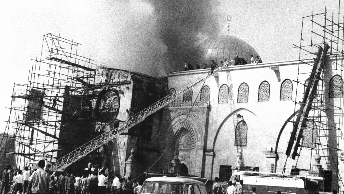 A crowd gathers around Al-Aqsa Mosque as firefighters work to extinguish a fire in Jerusalem on August 23, 1969.