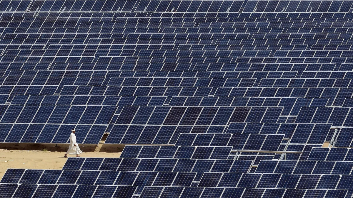  A worker walks through the Roha Dyechem solar panel farm, an installation part of the government’s clean energy initiative, in Rajasthan, India, on August 23, 2015.