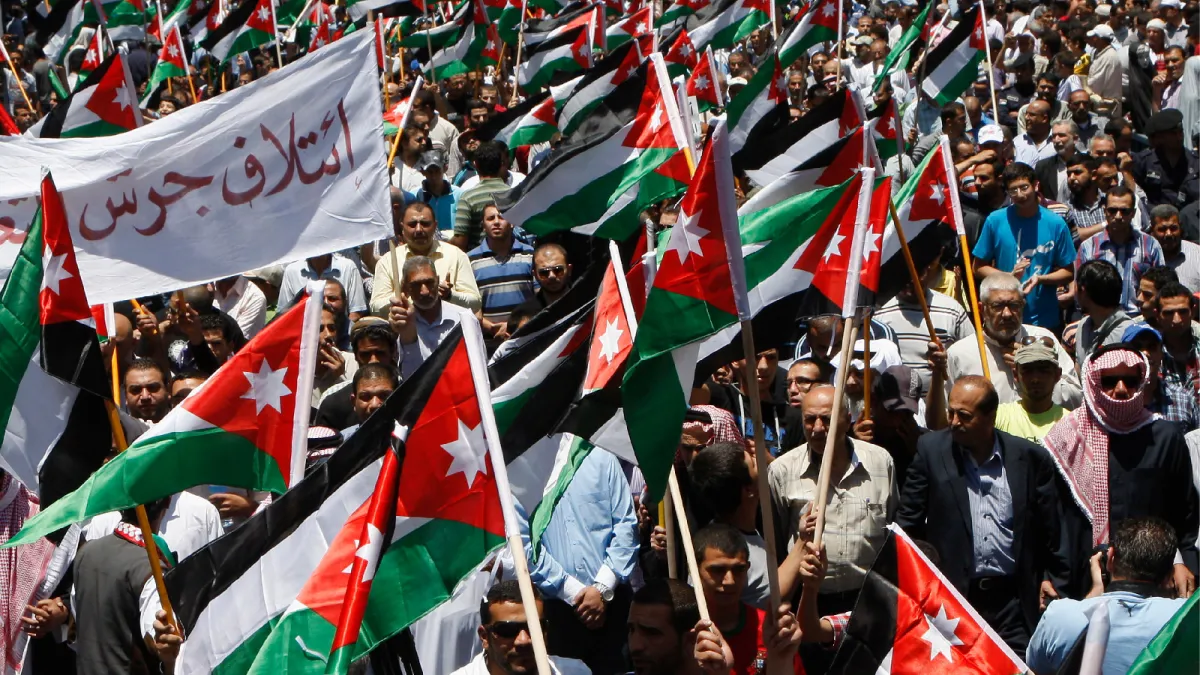 Demonstrators from the Islamic Action Front wave Jordanian flags, demanding political and economic reform and government transparency in Amman, Jordan, on June 14, 2013.