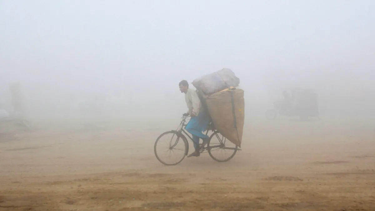 A man rides his bicycle through smog in Lahore, Pakistan on November 20, 2017.  