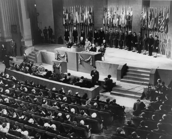 U.S. President Harry S. Truman (behind the podium) addresses the closing session of the UN conference in San Francisco, California, on June 26, 1945.