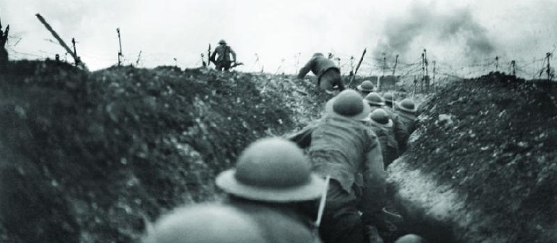 Soldiers moving through a trench in World War One