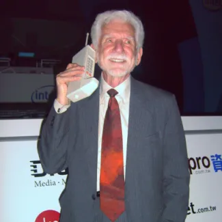 Martin Cooper, inventor of the handheld cellular mobile phone, holds a 1973 Motorola DynaTAC prototype in Taipei on June 5, 2007.