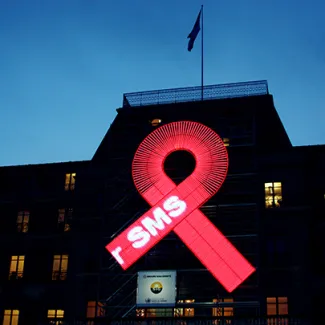 A red ribbon, a symbol of solidarity with people living with HIV/AIDS, is displayed on the façade of the UN Human Rights Office's headquarters in Geneva, Switzerland, on January 28, 2011.